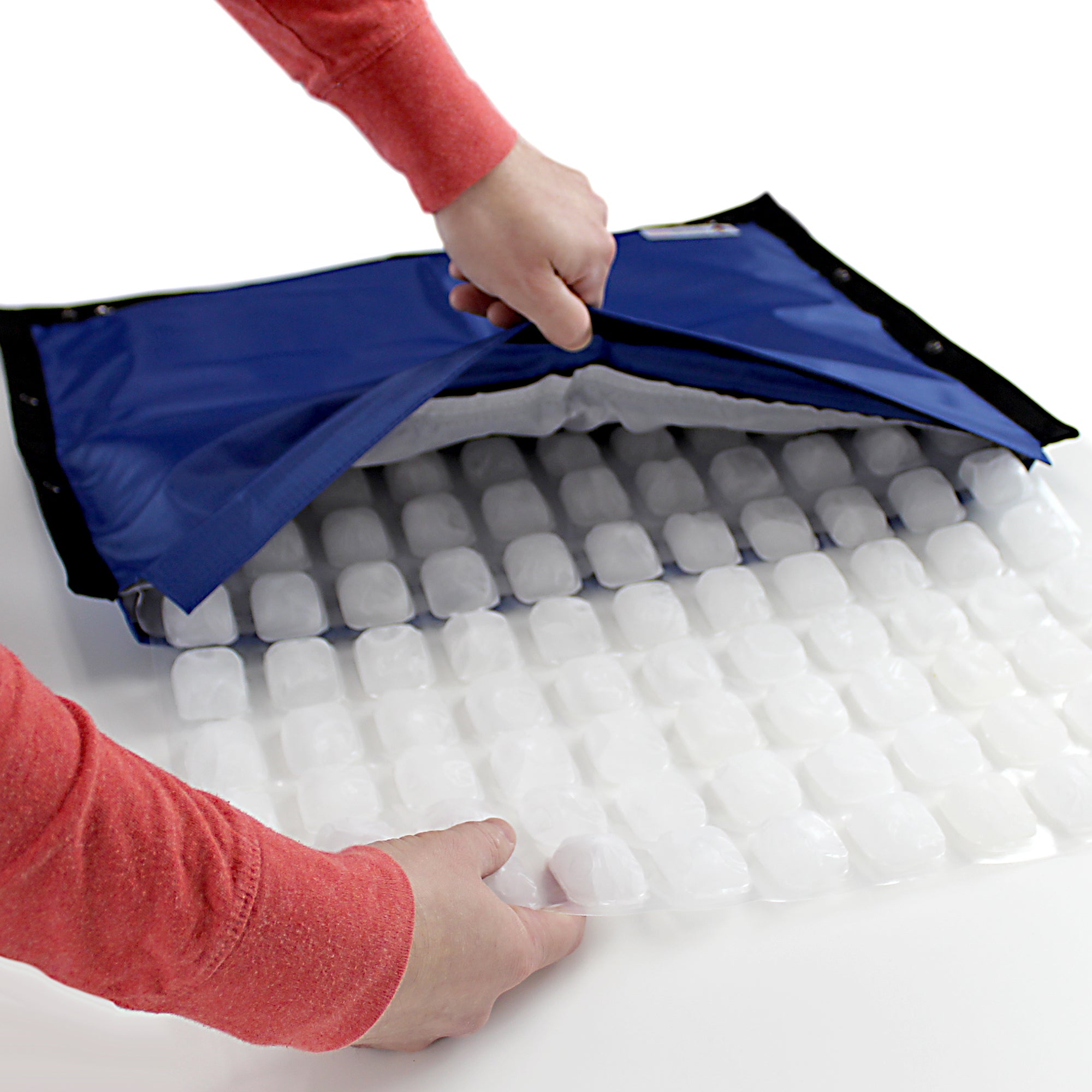 CoolerDog Hydro Cooling Mat, black/blue, with person inserting refill ice sheet