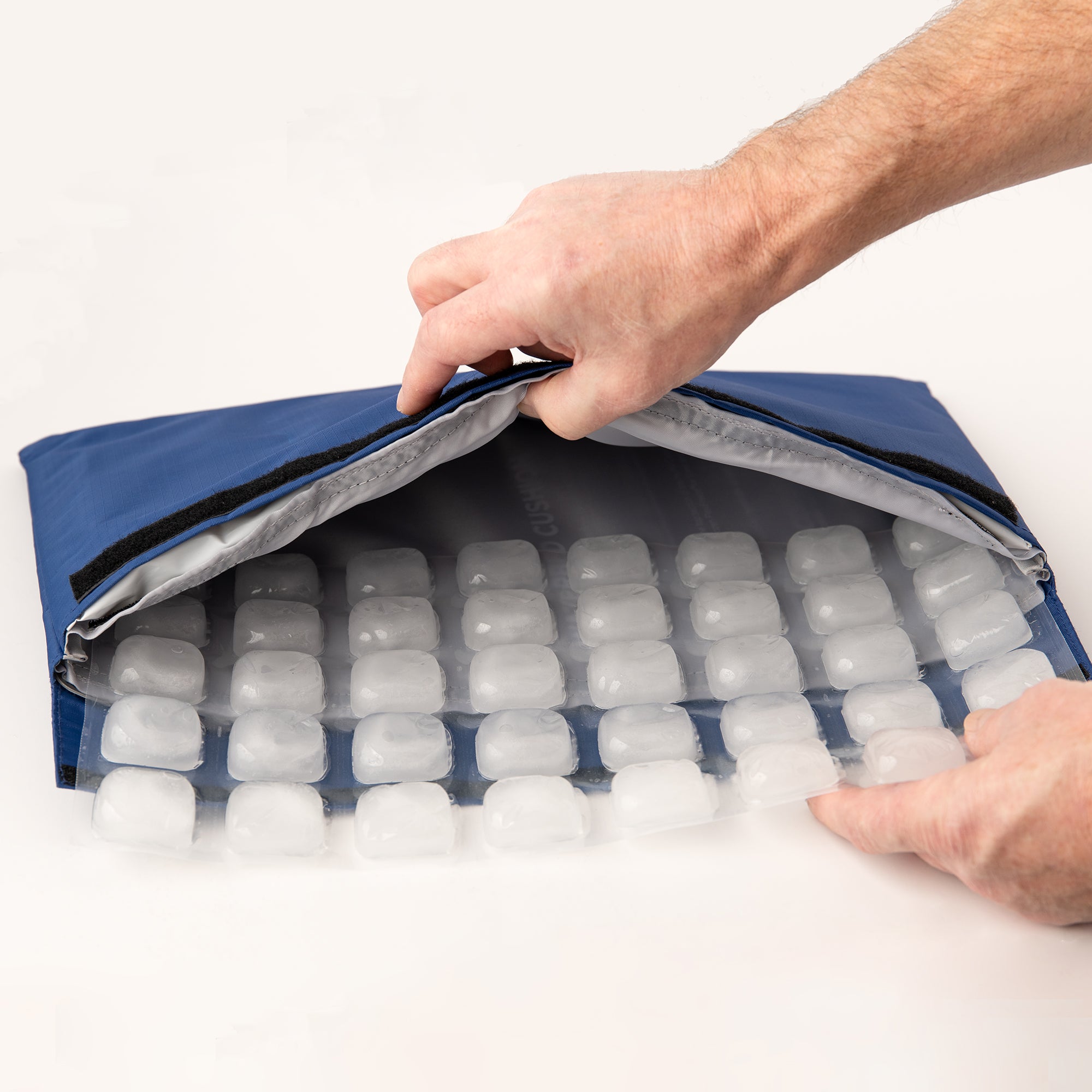 CoolerDog Mini Hydro Cooling Mat with refreezable refill ice being inserted