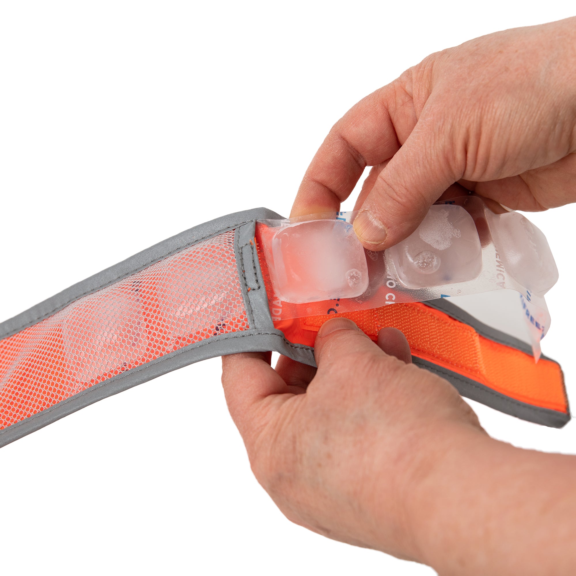 Refreezable ice strip being inserted into CoolerDog Hi-Vis collar, orange