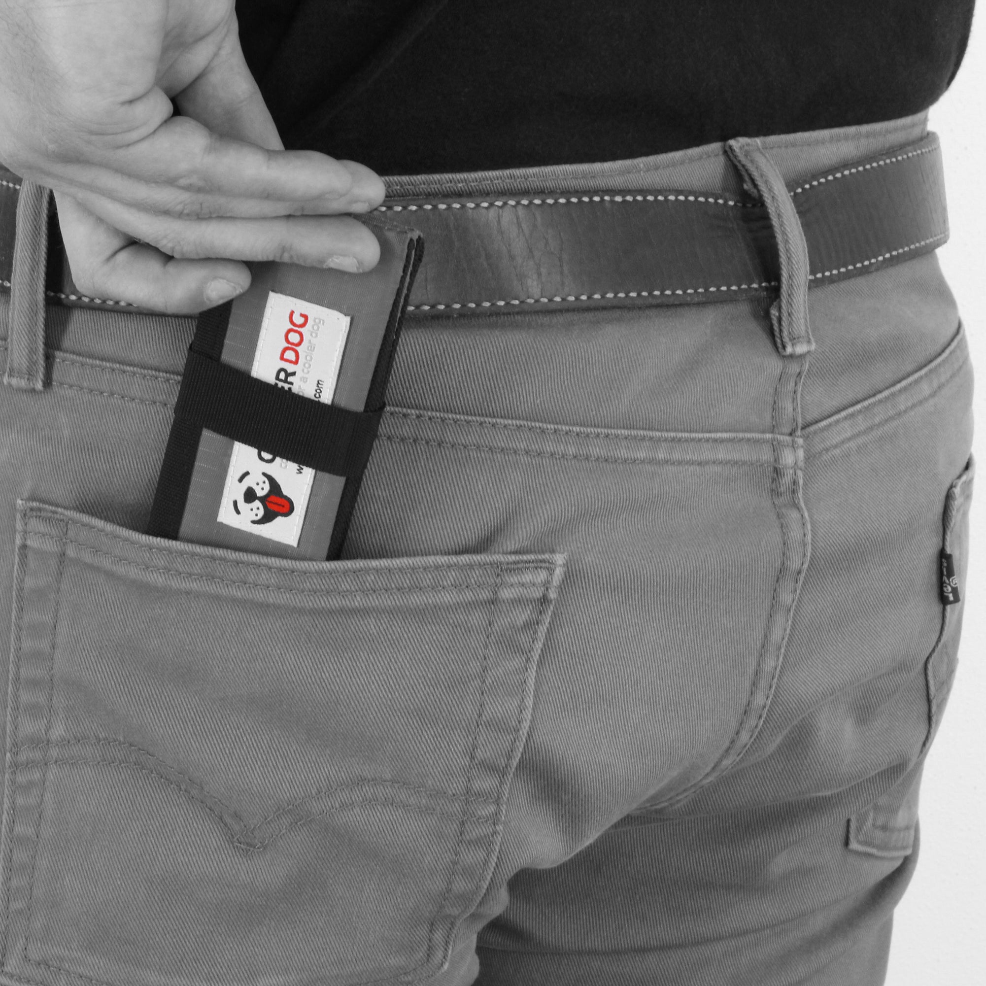 Man placing a folded up CoolerDog portable dog bowl in his back pocket